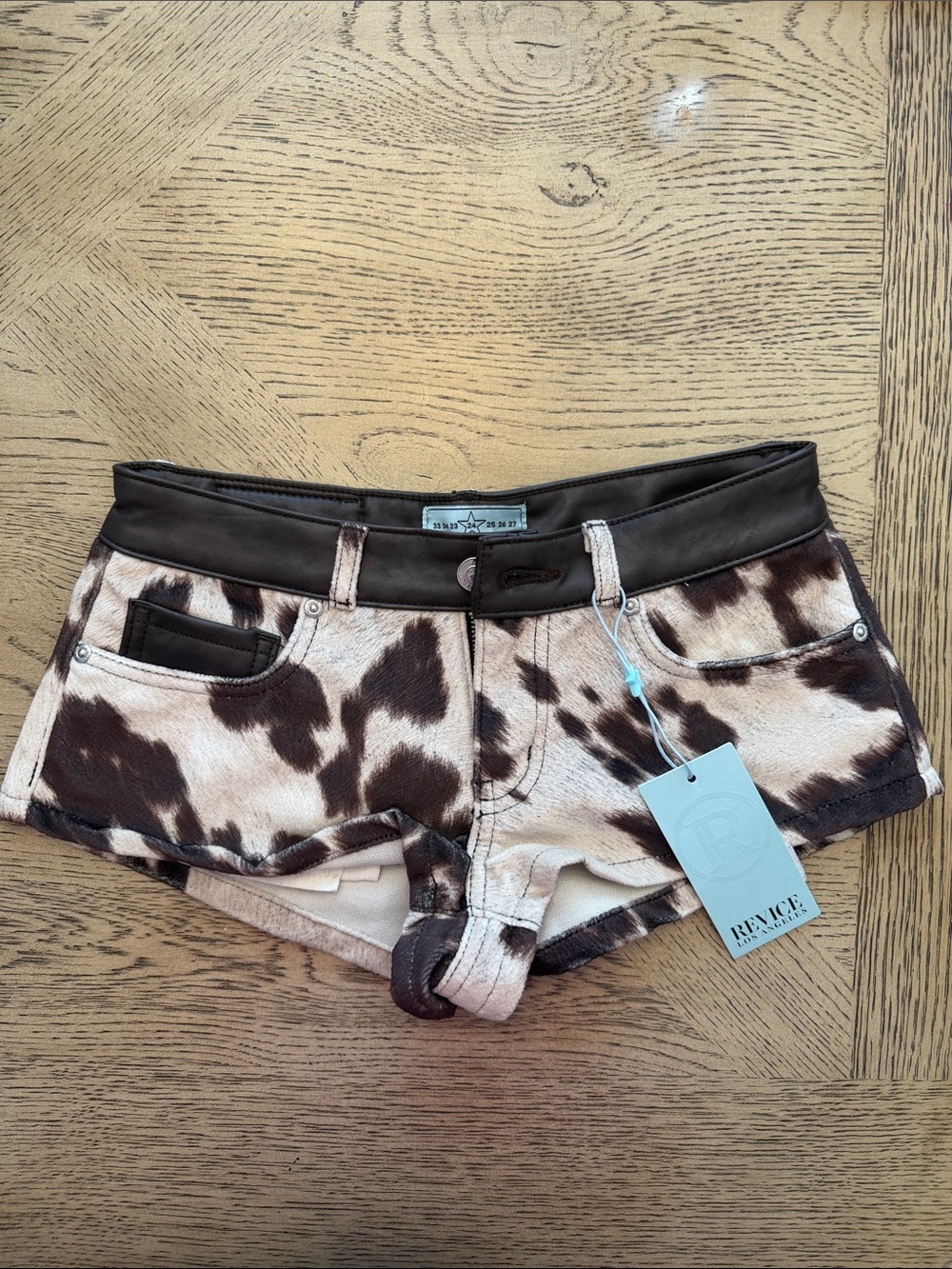 REVICE Cowhide Print Low-Rise Jean Shorts in Brown and White